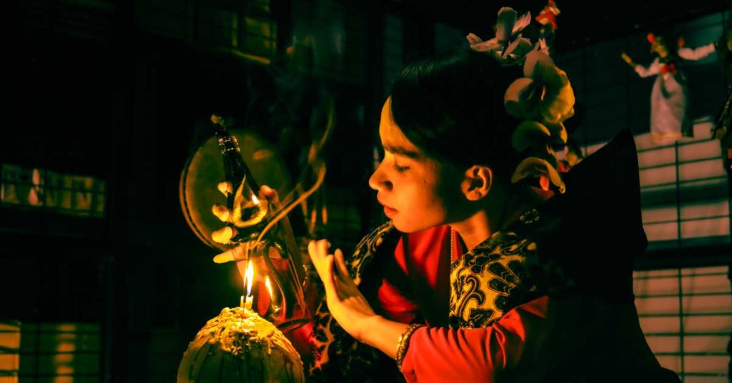 Shaman (Bomoh) performing a ritual with skull candle